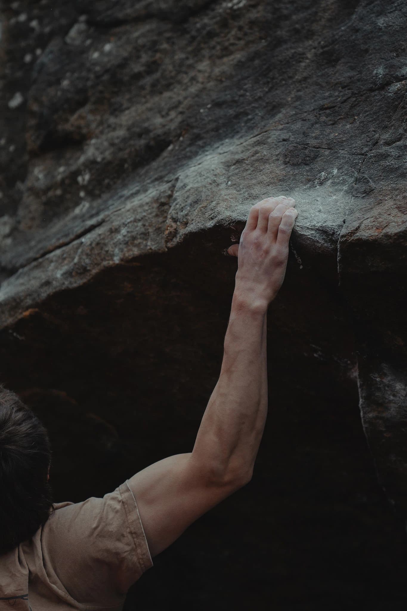 Close-up of a climber gripping rock after a session