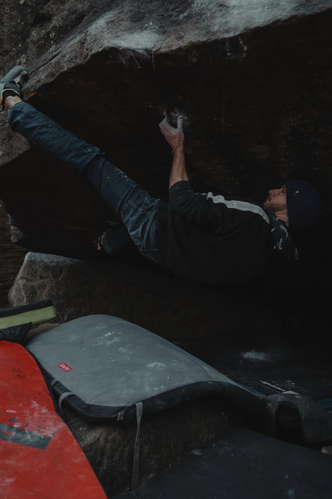 Climber holding an overhang with chalked hands