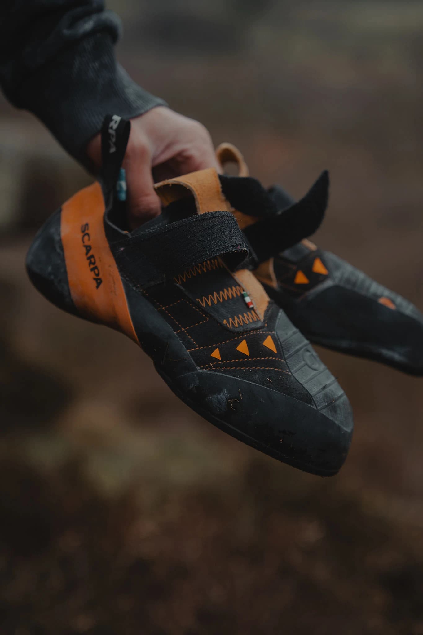 Climbing shoes held after a session outdoors